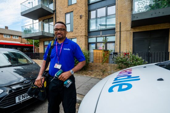 Wandle repairs colleague smiling in front of building