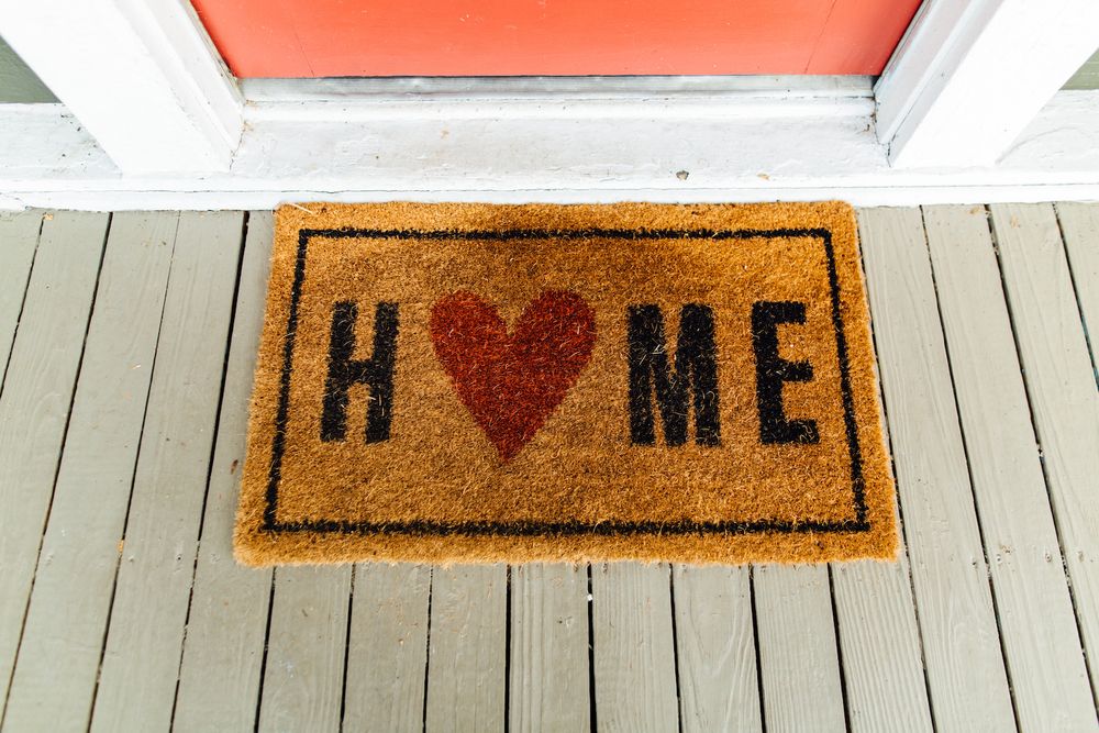 door mat that says home